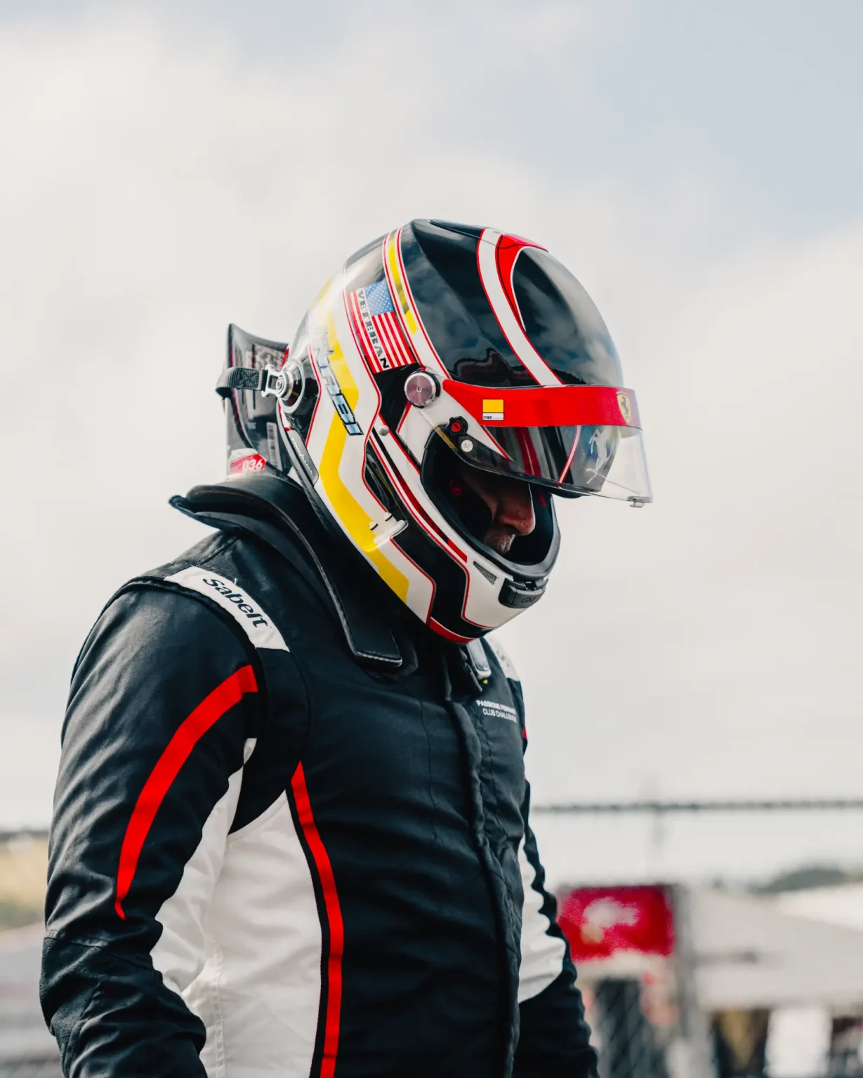 A racing driver in helmet and race suit