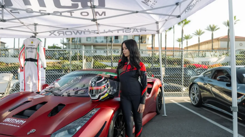 Gotham Motorsports drivers beside a red Ferrari at an event