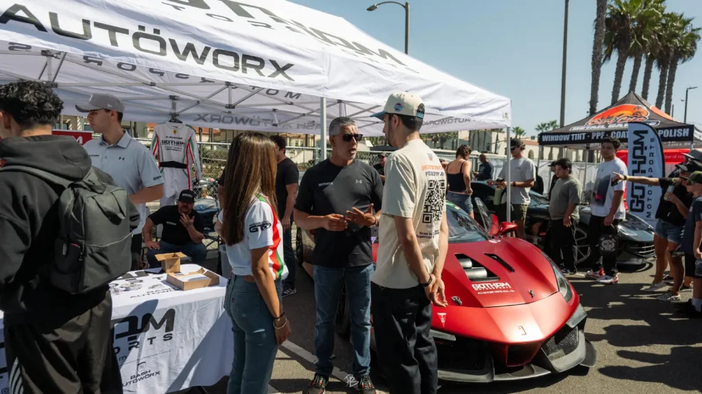Gotham Motorsports display with a red Ferrari at an event
