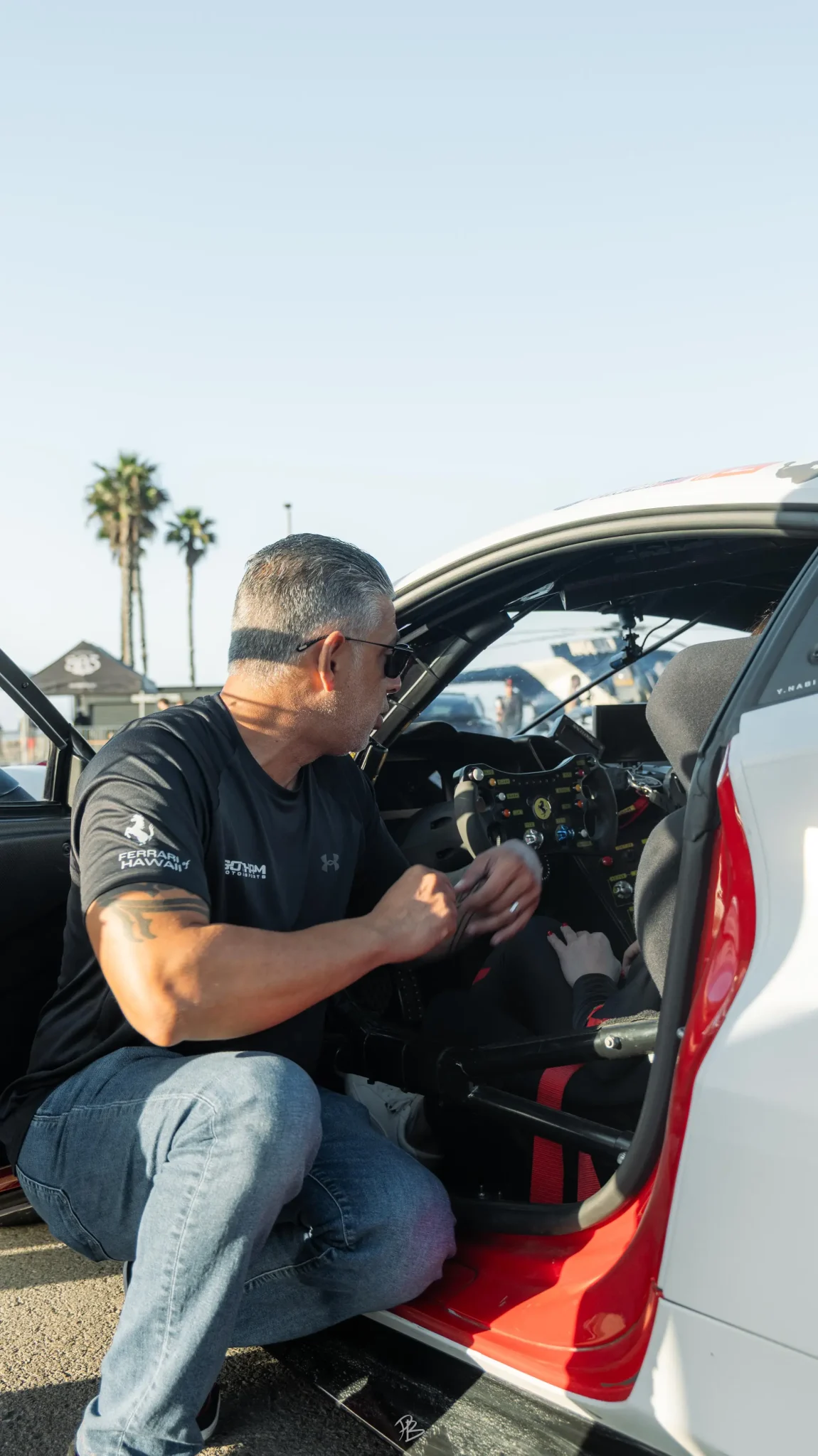 A Gotham Motorsports team member at the cockpit of a race car
