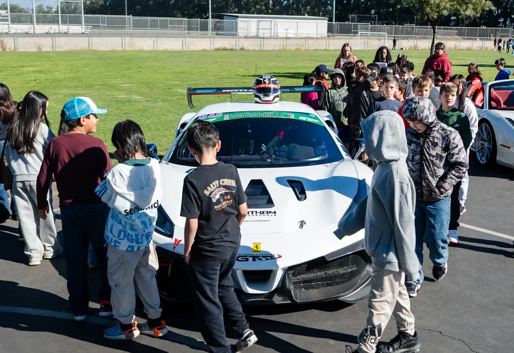 Students gathered around the Gotham Motorsports race car